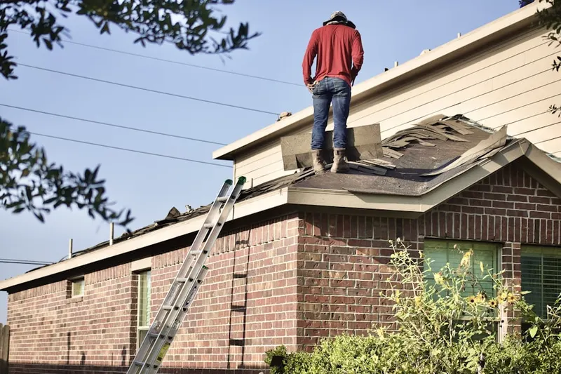 Professional roofer working on a residential roof in Van Nuys